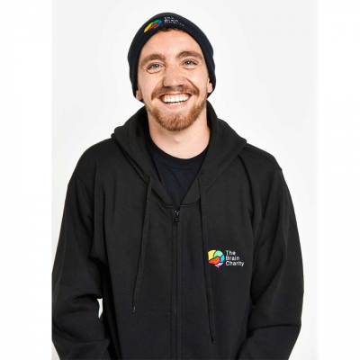 Smiling man in a Brain Charity hoodie