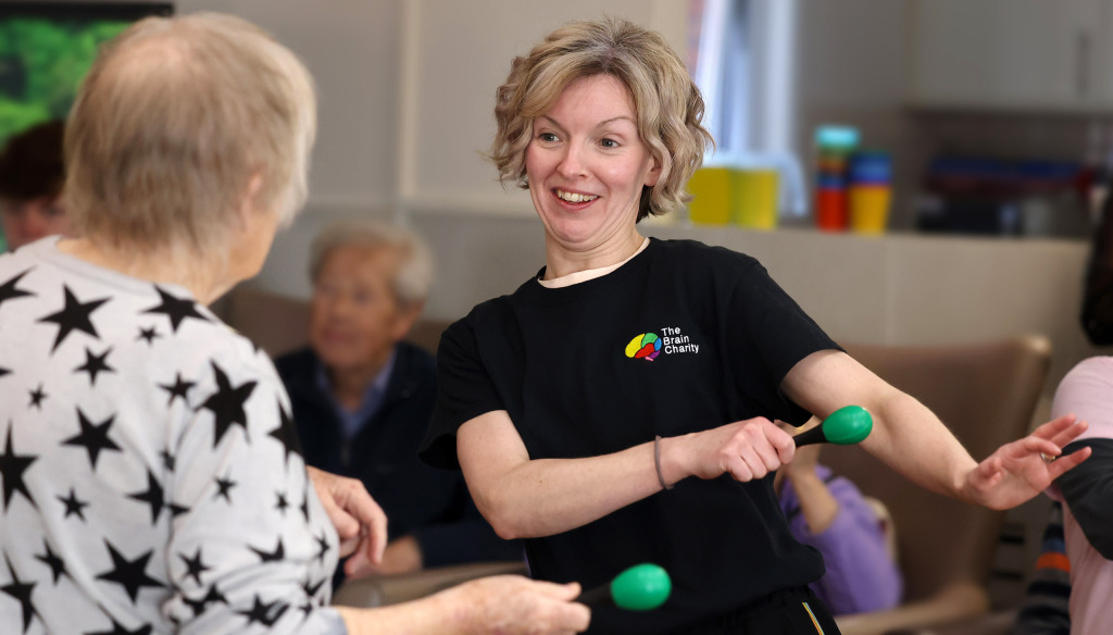 Care home resident participates in a Music Makes Us! SALT through singing class from The Brain Charity in Liverpool