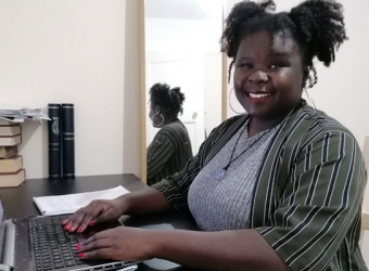 The Brain Charity's Information and Advice Officer Vanessa sitting at desk