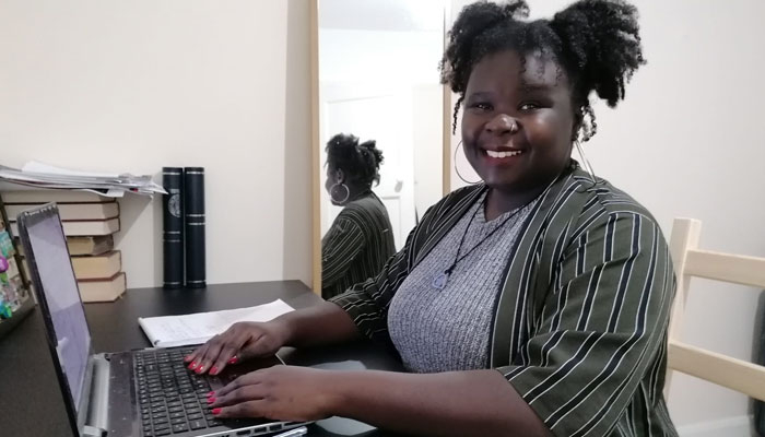 The Brain Charity's Information and Advice Officer Vanessa sitting at desk