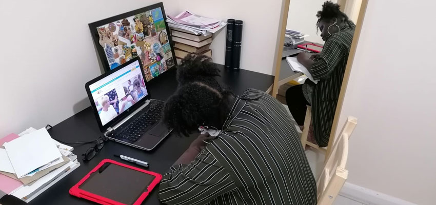 The Brain Charity's Information and Advice Officer writing at desk