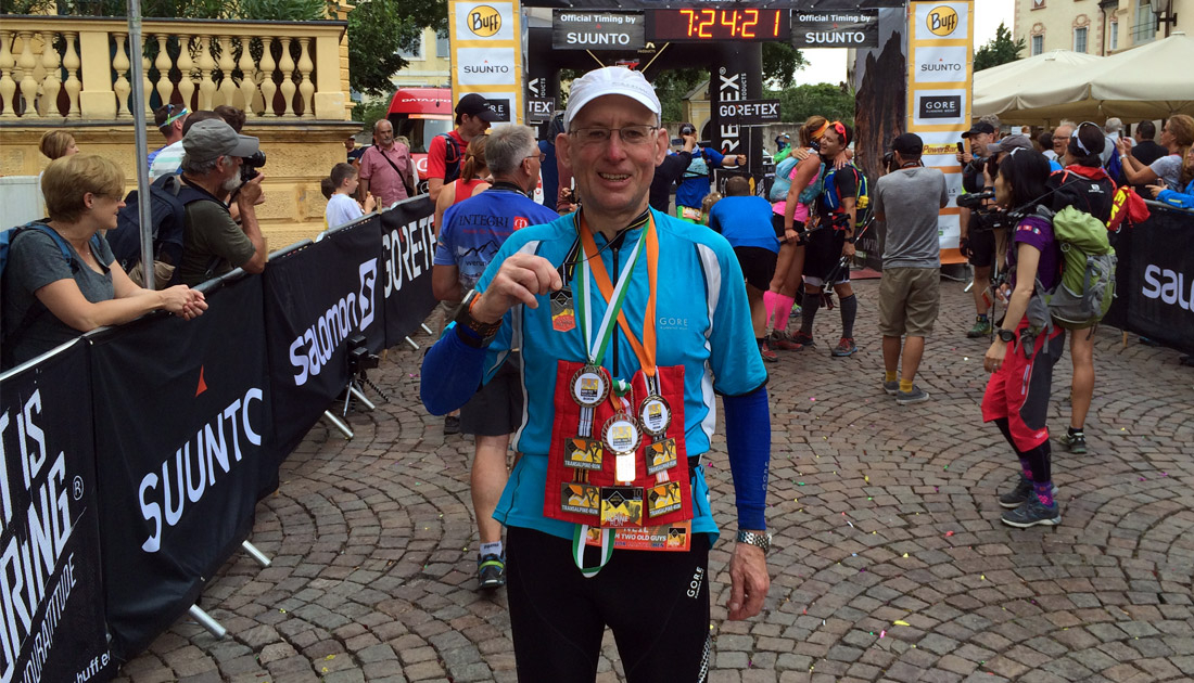 Brain haemorrhage survivor Neil Rhodes with medal after completing a Trans-Alpine run