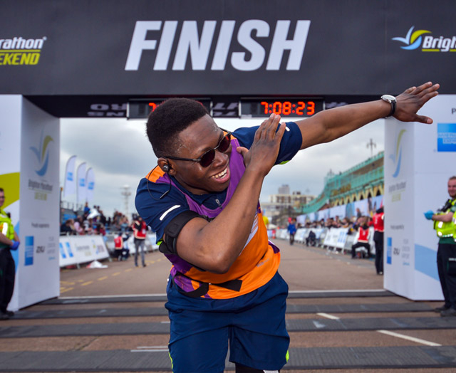 Runner celebrates at end of a marathon challenge for charity