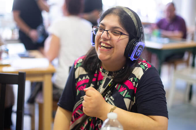 A client at The Brain Charity listening to music via headphones.