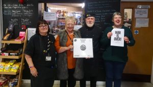 Some of The Brain Charity team with the donated limited edition acetate of the John Lennon Yoko Ono single-‘Happy Xmas (War is Over)'