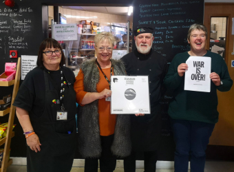 Some of The Brain Charity team with the donated limited edition acetate of the John Lennon Yoko Ono single-‘Happy Xmas (War is Over)'