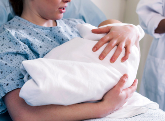 New mother in hospital holding baby