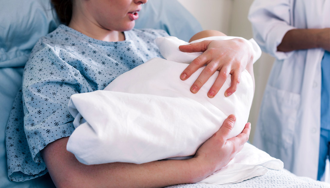 New mother in hospital holding baby