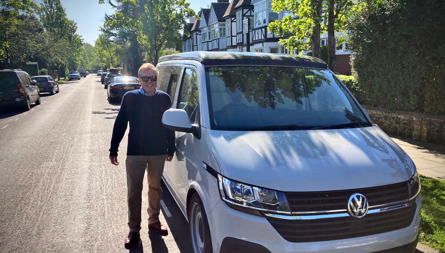 James standing beside van