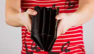 A woman's hands holding an empty purse