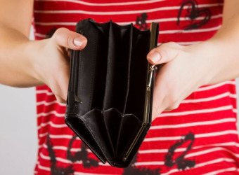 A woman's hands holding an empty purse