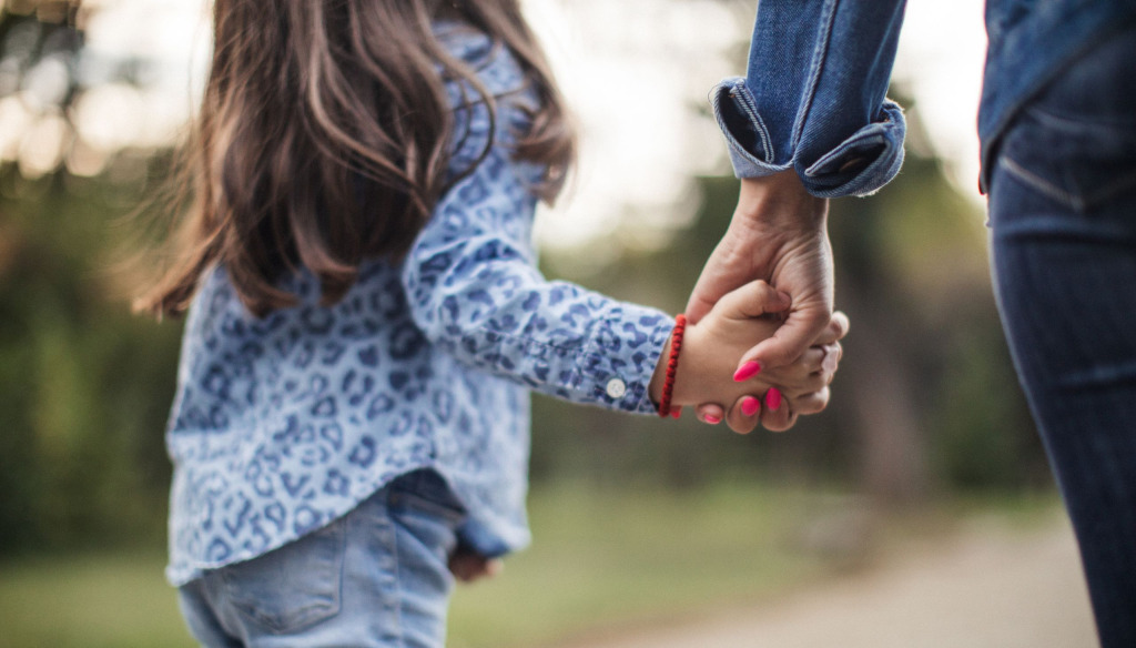 Child walks with mother hand in hand