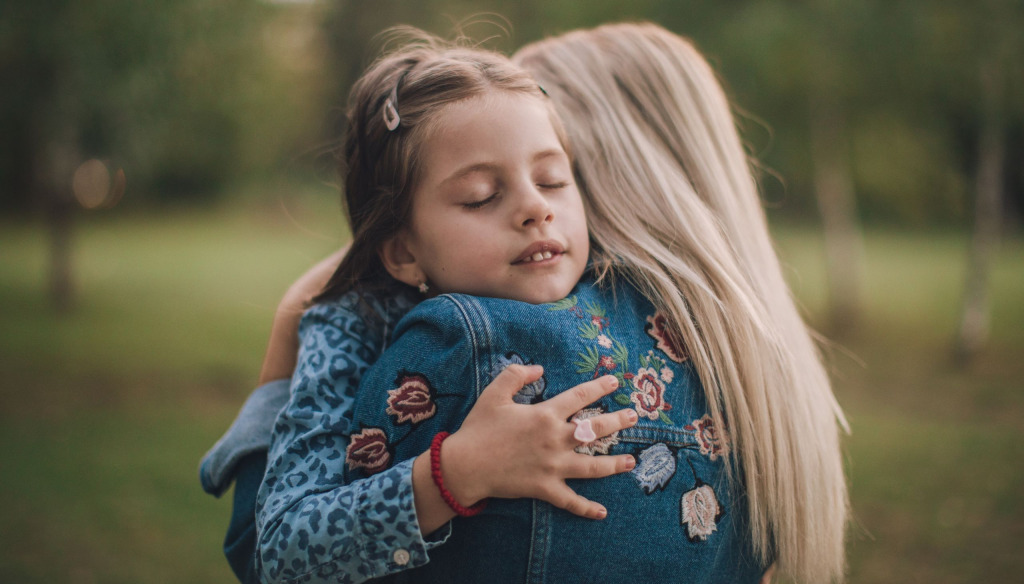 Daughter hugs her mum