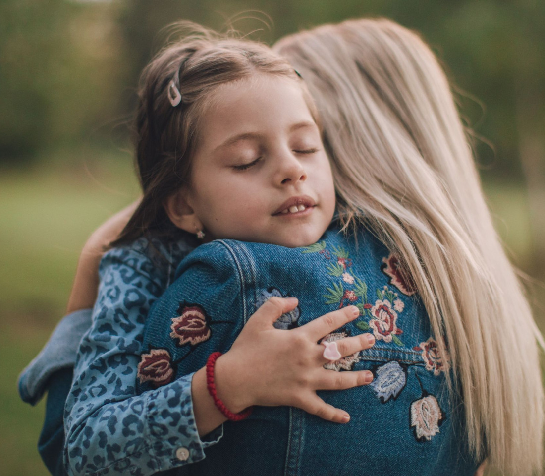 Daughter hugs her mum
