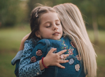 Daughter hugs her mum