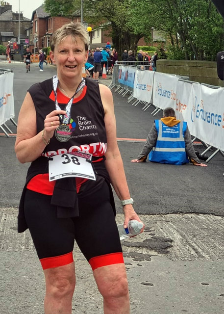 Fundraiser Mary with her medal at the finish of the Horwich Triathalon