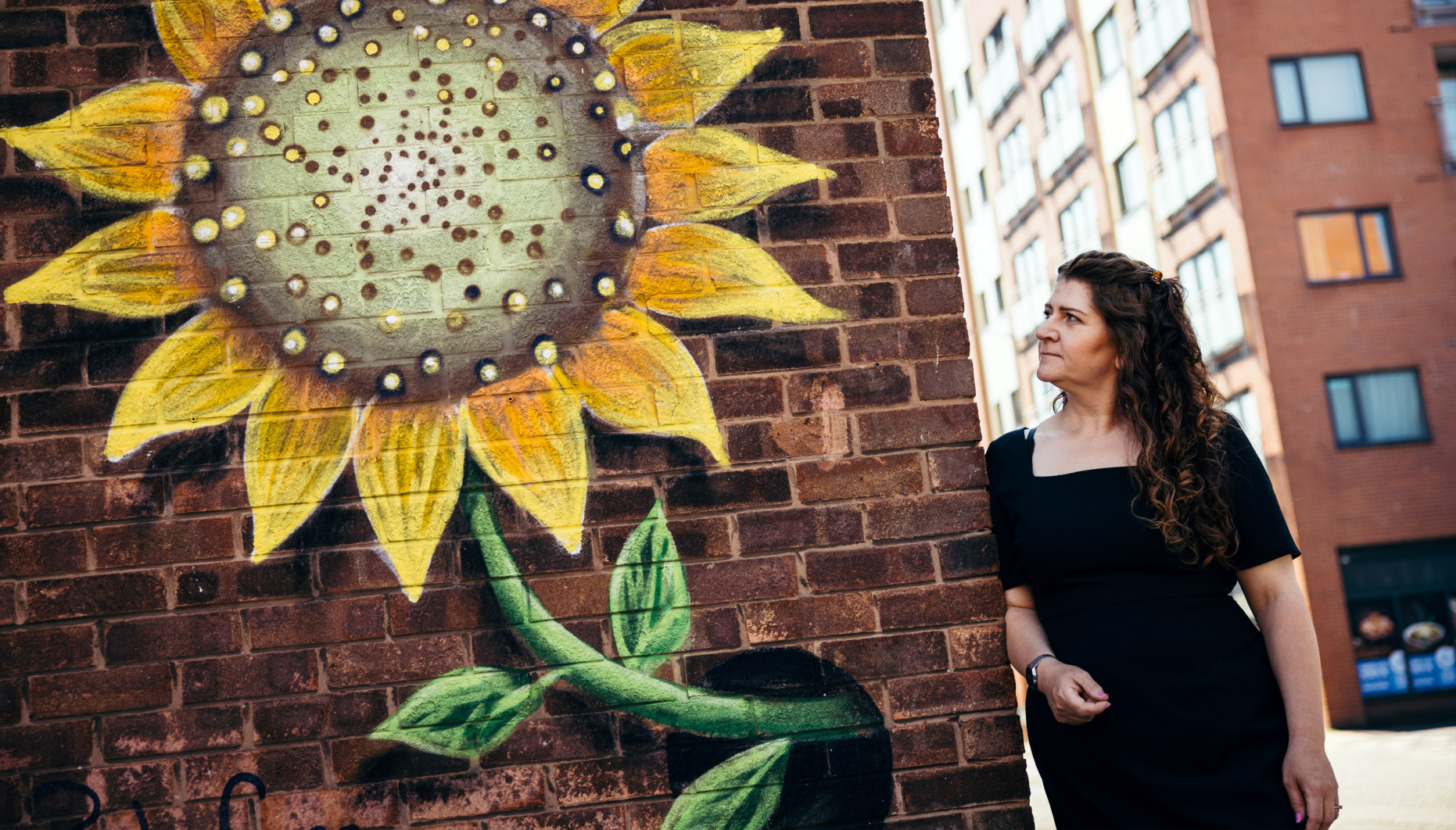 Nanette mellor looking at sunflower wall art in The Fabric District