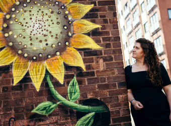 Nanette mellor looking at sunflower wall art in The Fabric District