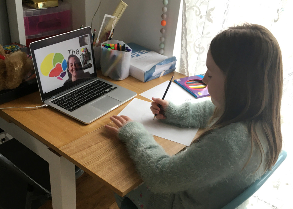 Young person using a computer at home