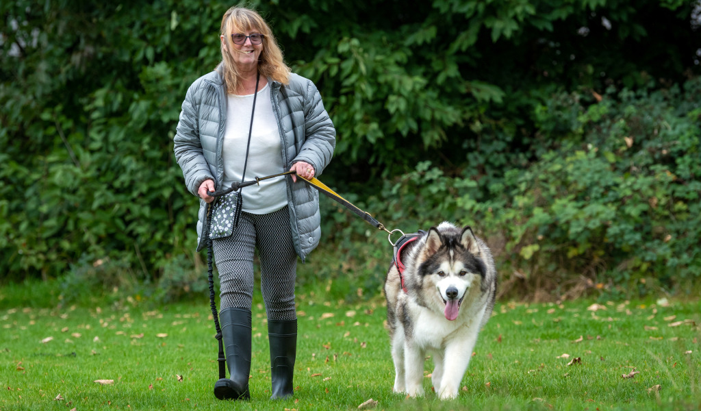 Karen walking in the park with Blue Cross medal winner Storm