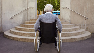 Man in wheelchair facing stairs