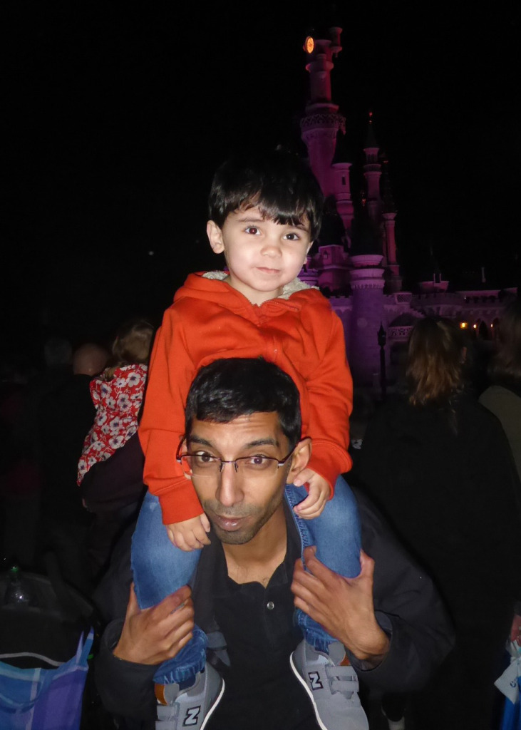 Rupak with his son at Disneyland