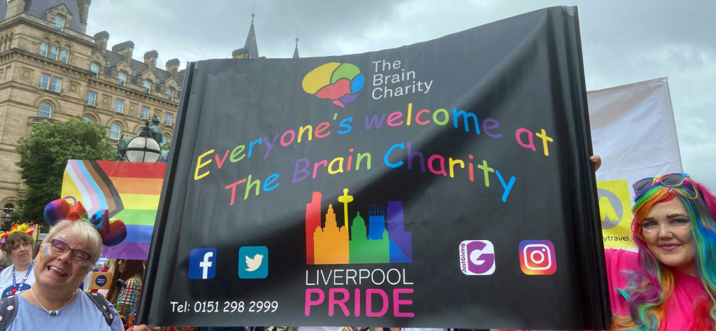 Supporters holding The Brain Charity banner at Liverpool Pride 2022