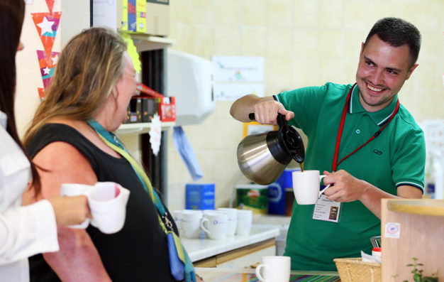 Volunteer serves coffee in The Brain Charity's Café