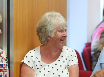 Two women and a man chatting and laughing