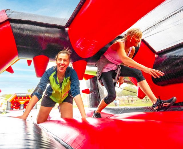 People in an inflatable obstacle course.