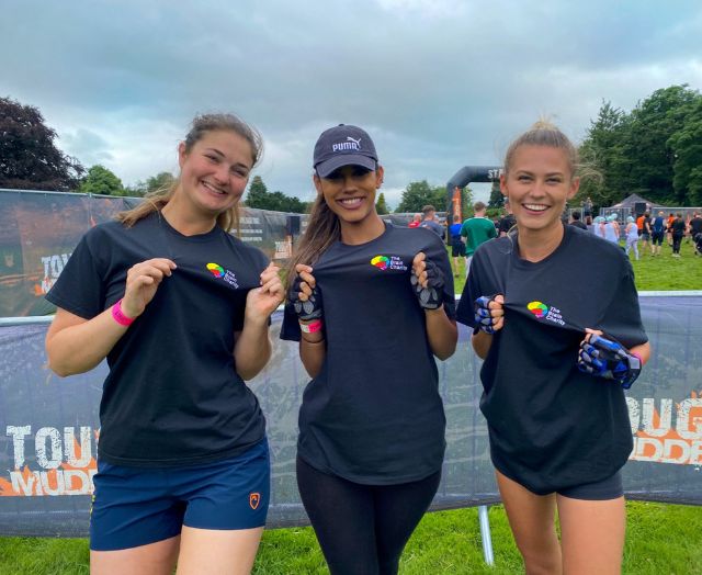 Three fundraisers wear Brain Charity t-shirts before beginning a Tough Mudder challenge.