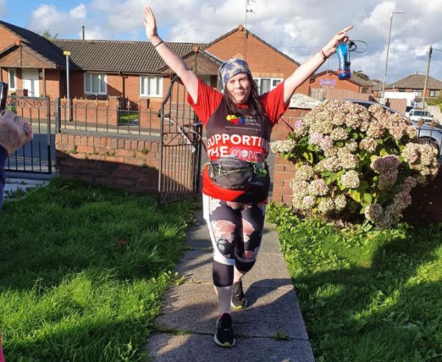 A fundraiser in a Brain Charity vest completes the Virtual London Marathon.