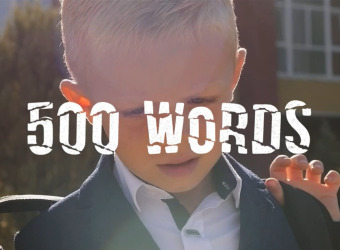 Title frame from the video showing a schoolboy with 500 words written acros screen