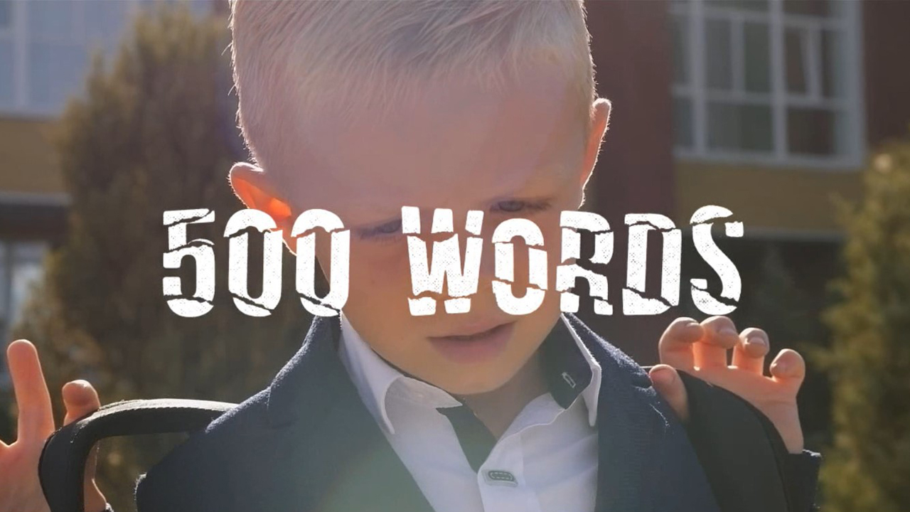 Title frame from the video showing a schoolboy with 500 words written acros screen