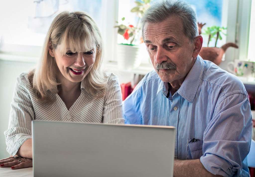 A father and daughter looking at a laptop together