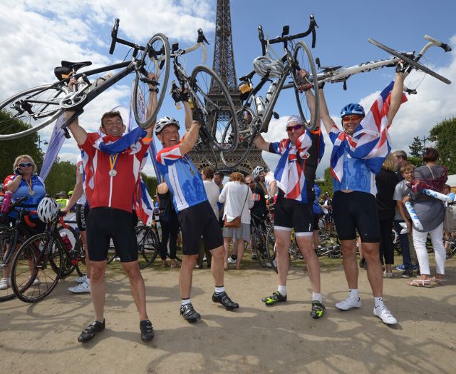 Cyclists celebrate arriving at the Eiffel Tower in Paris