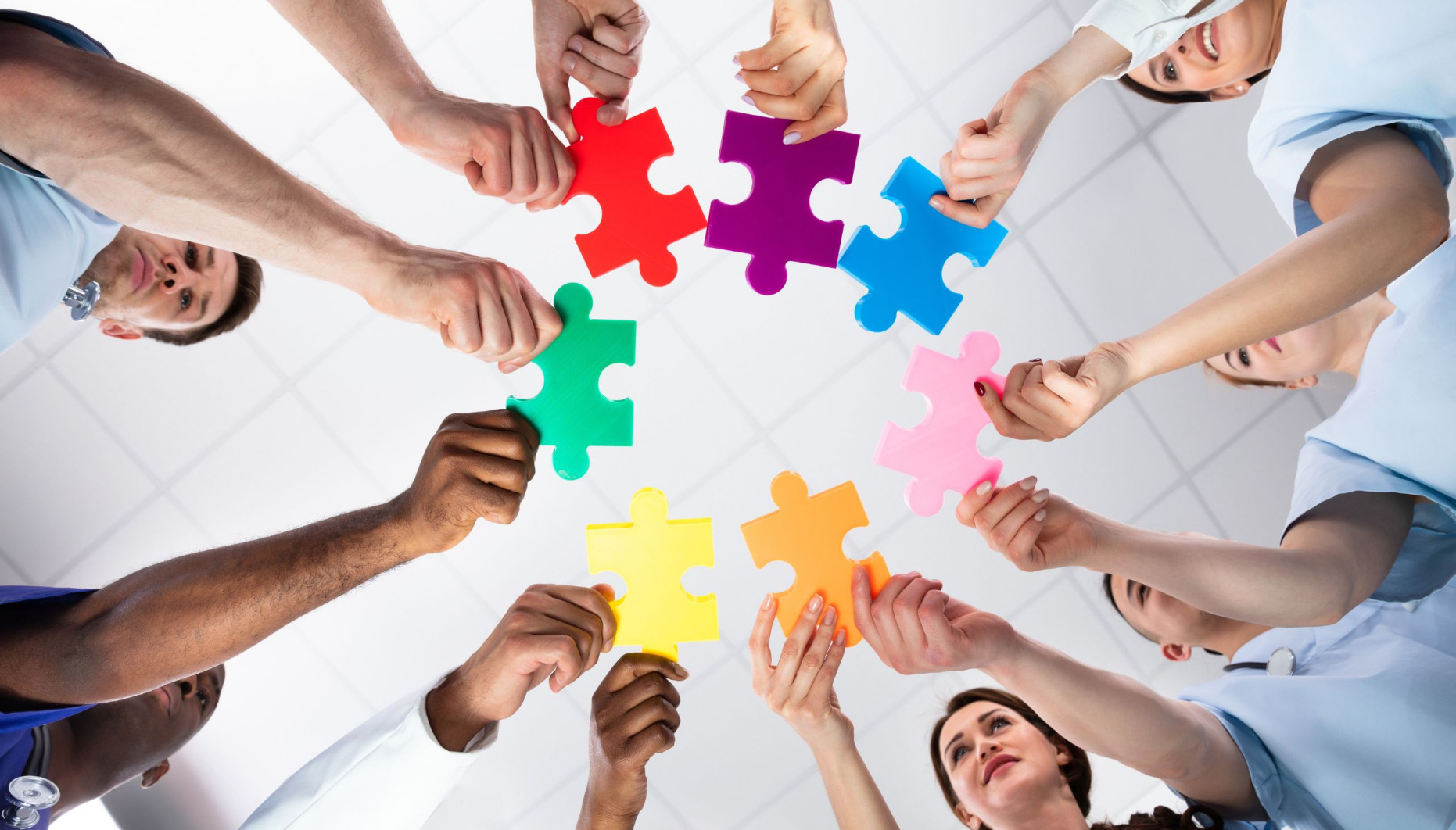 Neurodiversity - a circle of people each holding their own unique puzzle piece