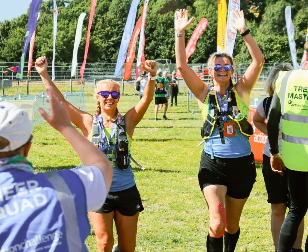 Friends crossing the finish line of the Peak District Ultra Challenge