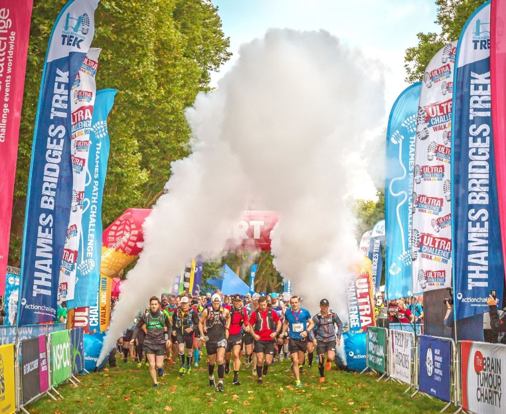 Runners complete an Ultra Challenge with smoke jets in background