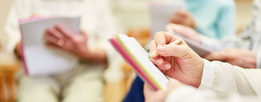 People sitting around a table together making notes