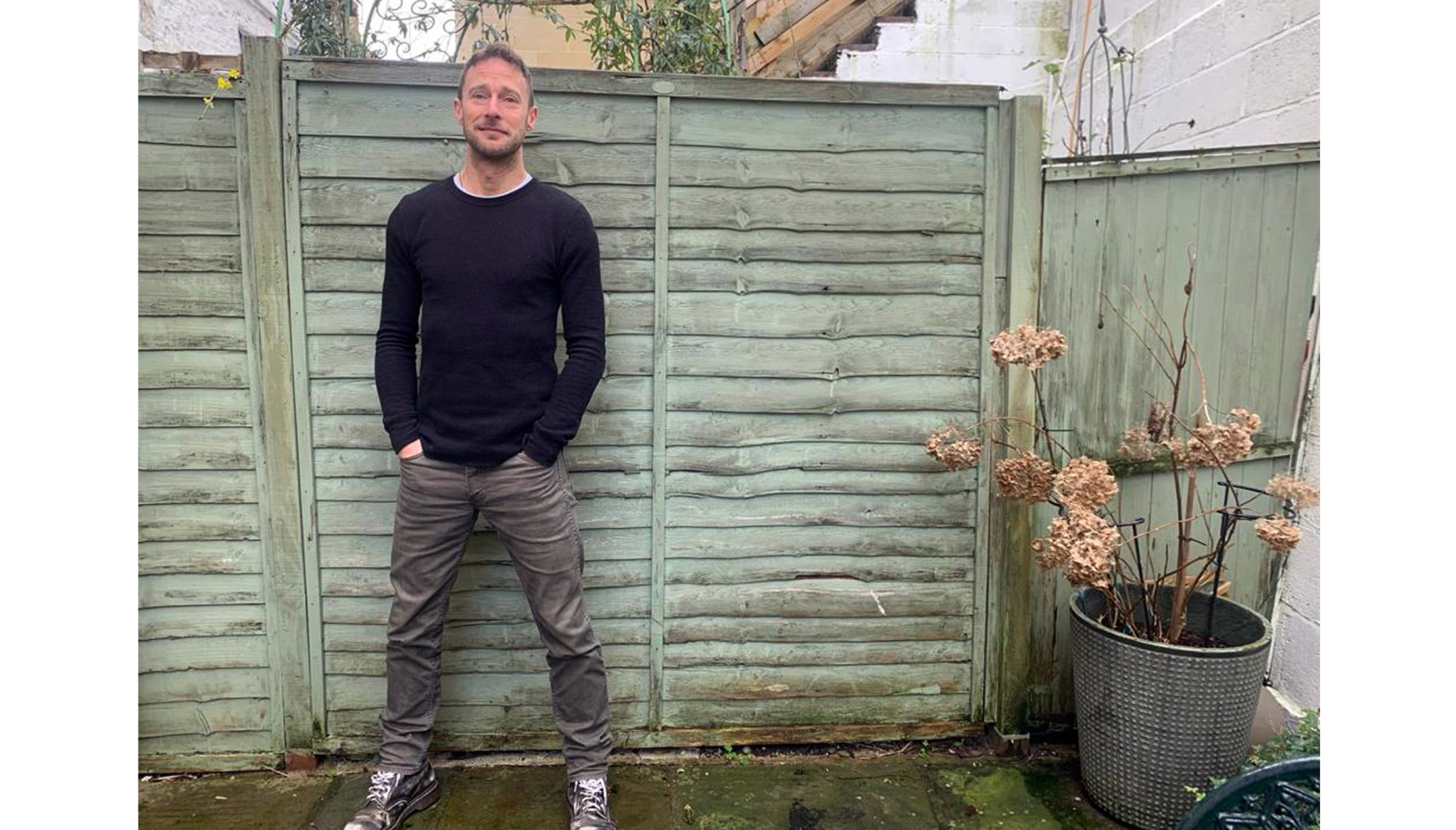 Author James standing in a garden
