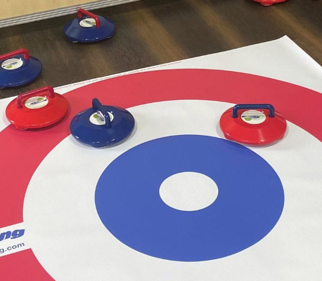 A new age kurling mat with pucks in play