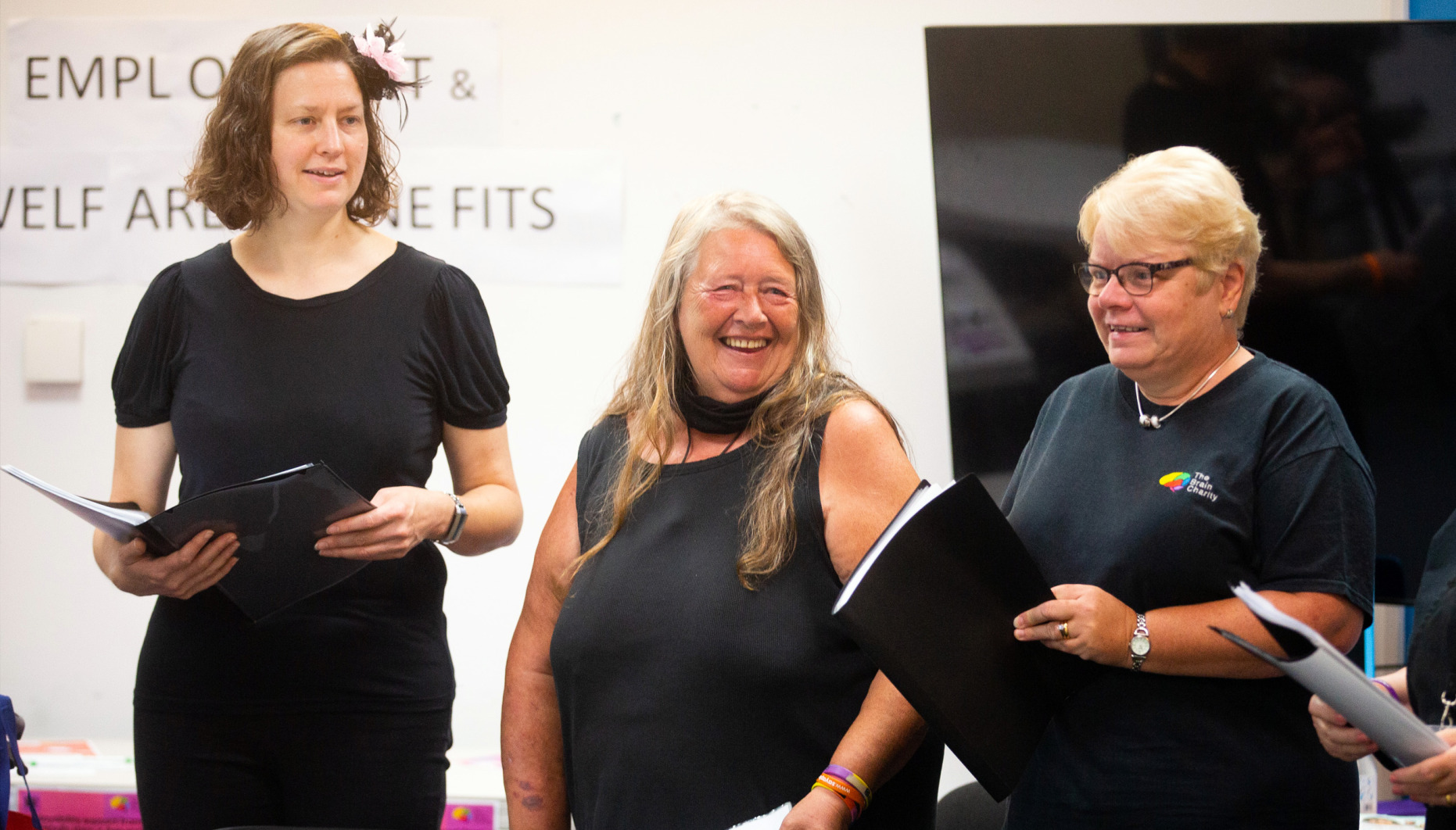 Members of The Brain Charity's sing and a social group performing at an event