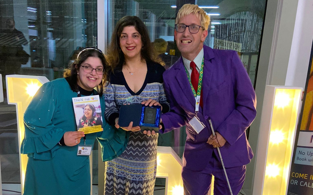 3 members of The Brain Charity team collecting The Volunteering Organisation of the Year Award at Liverpool John Moores University Students Union Society and Volunteering Awards