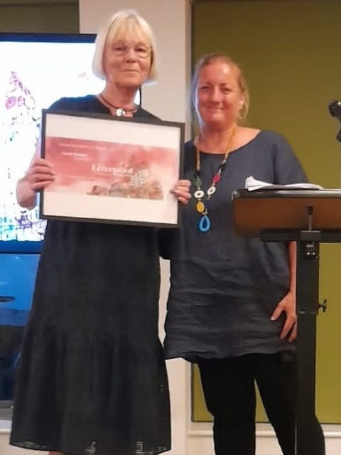 Liverpool Poetry Prize winner Carole Bromley receiving her prize from CEO Pippa Sargent