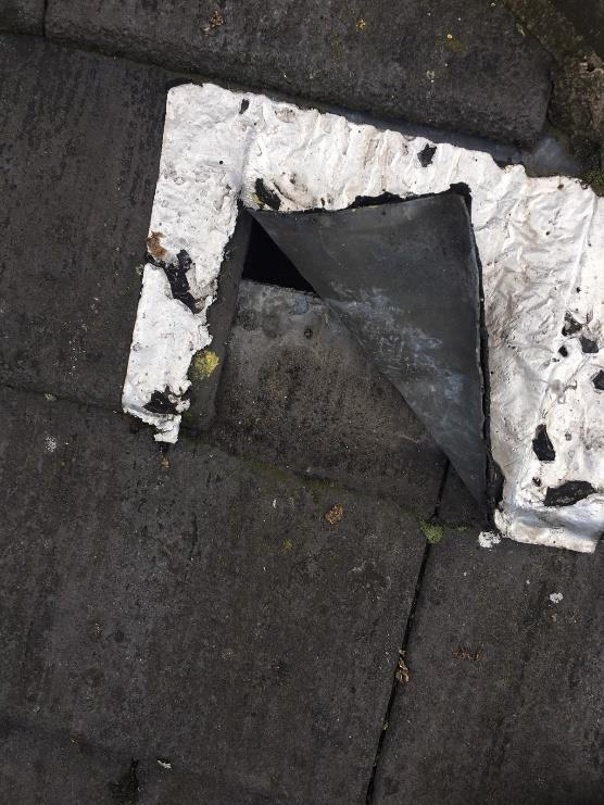 A lifting tile on The Brain Charity's damaged roof