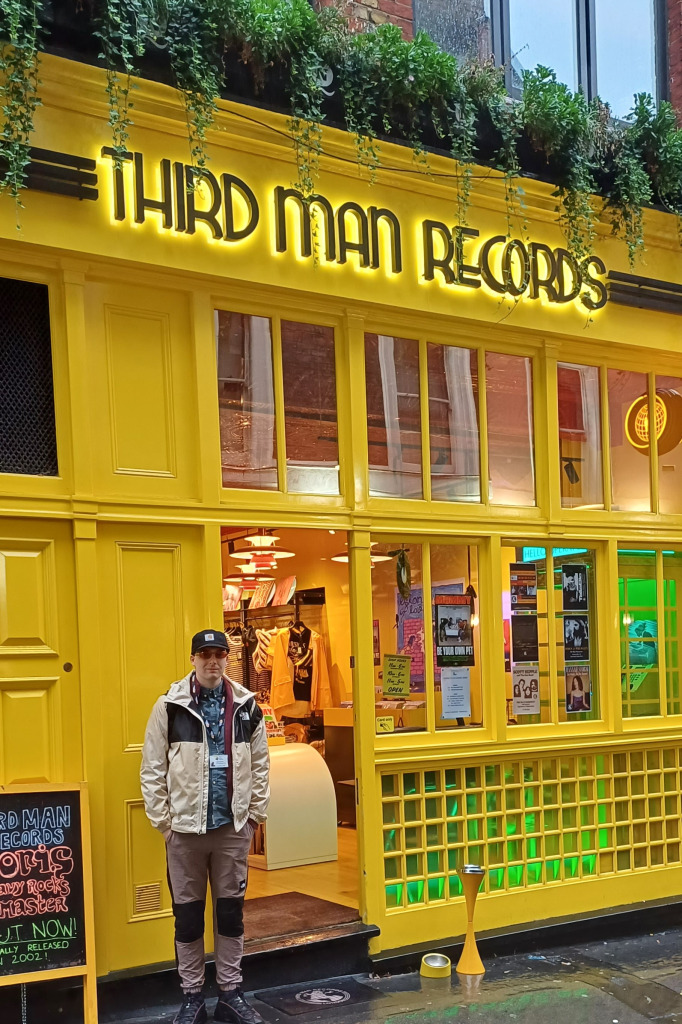 man in baseball cap and dark glasses standing outside Third Man Records in London
