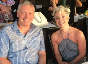 Steve with his late wife Helen. They are sitting in a bar, smiling at the camera