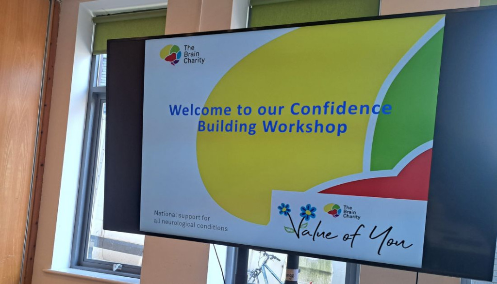 A digital display with the words Welcome to our confidence building workshop.