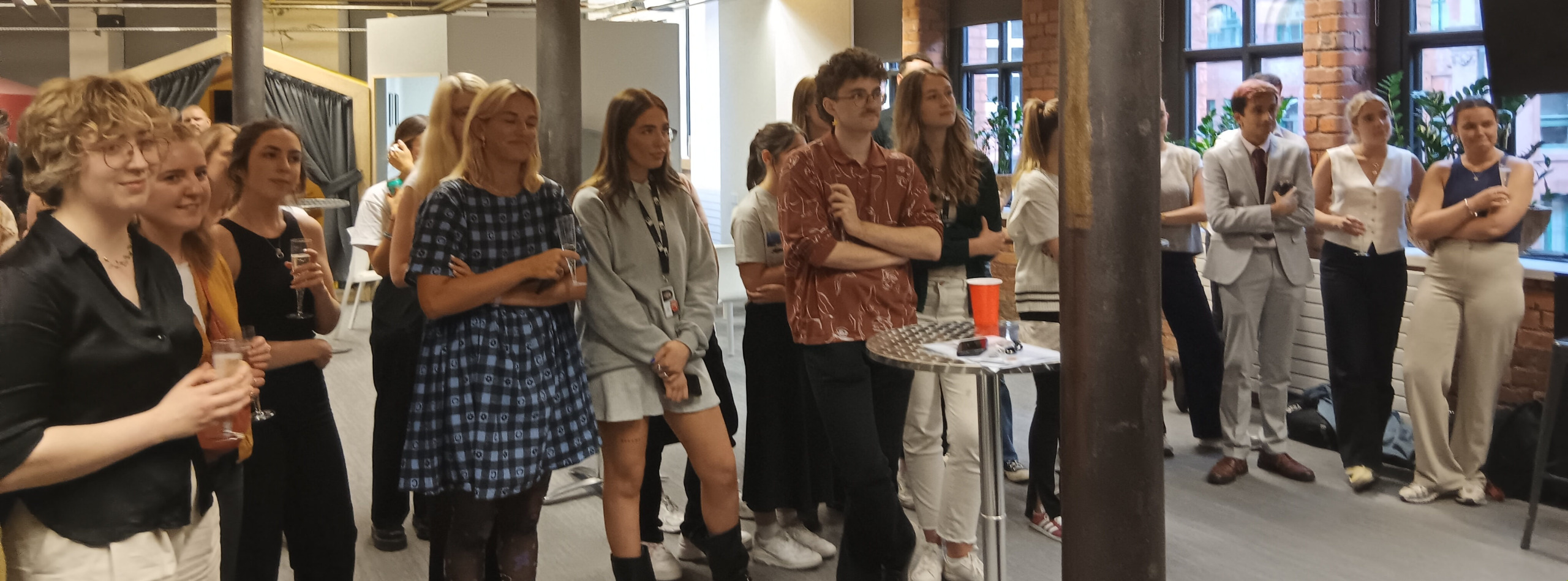 A group of young corporate volunteers listening to a presentation